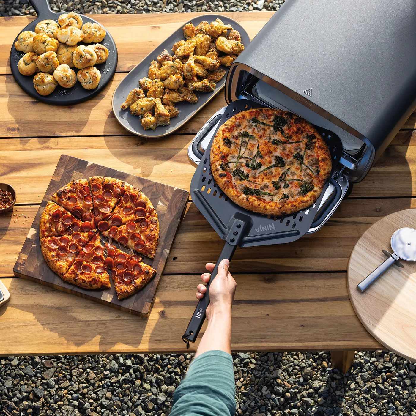 Ninja MO201UK InUse BackYard OnTable Wings Desert Casserole RemovingPizza Man